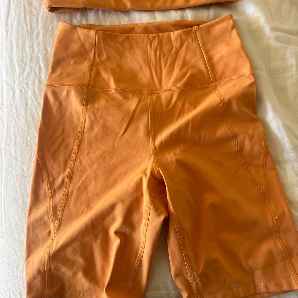 girlfriend collective orange ribbed sports bra and high-waist biker shorts - Picture 2 of 4